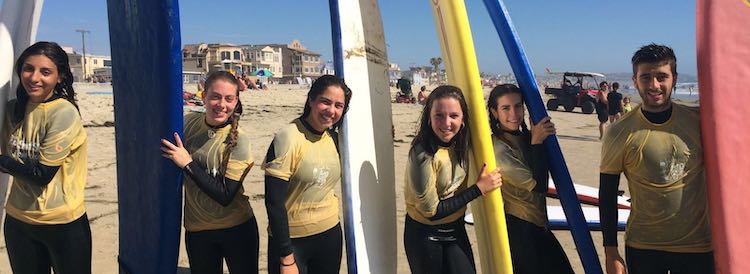 International Students Holding Surf Boards