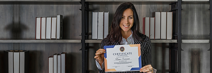 a woman smiling and holding up a certificate